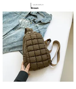 Detailed view of brown quilted nylon crossbody bag with adjustable strap and metal zipper