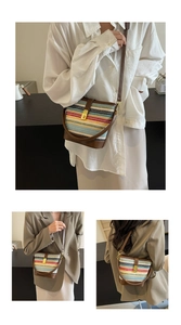 Detail of bohemian rainbow woven bucket bag with leather base and gold metal twist lock