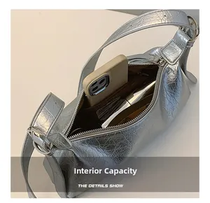 Internal capacity of silver metallic baguette bag with phone for scale