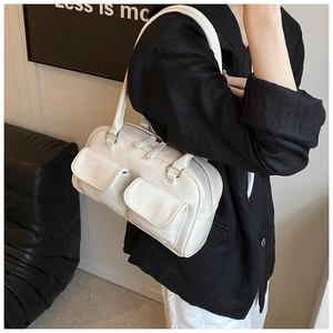 Close-up of cream vintage underarm bag with double front flap pockets and glossy texture