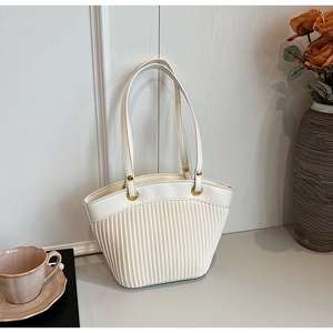 Detail of off-white PU leather tote with vertical pleats and golden ring connectors