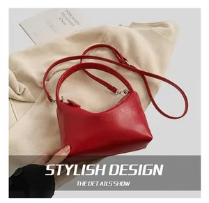Detail show of glossy red leather shoulder bag with silver hardware and adjustable strap