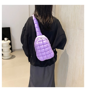 Detailed view of purple quilted nylon crossbody bag with textured stitch patterns