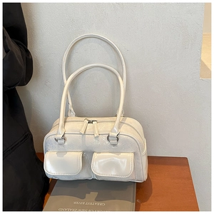Detail of a creamy white Boston bag in oil wax leather with double zips and silver hardware
