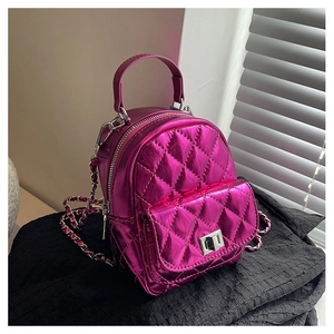 Detail of fuchsia quilted mini backpack with chain strap and metallic finish