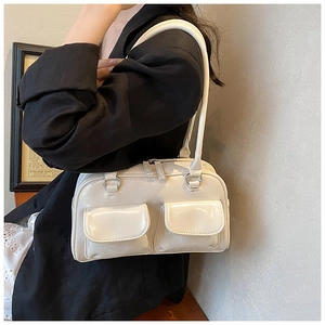 Glossy white faux leather shoulder bag with front flap pockets and slim straps