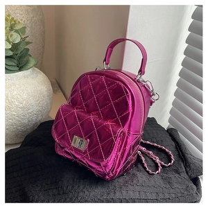 Detail of metallic plum quilted mini backpack with chain strap and metal turn-lock