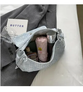 Detail showing the large interior capacity of this woven tote bag with silver chain