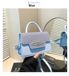 Close-up of light blue flap bag with textured stripes and metallic turn-lock closure