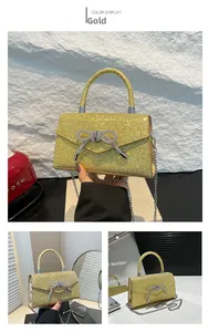 Macro view of gold sequin evening bag with sparkling silver rhinestone bow detail