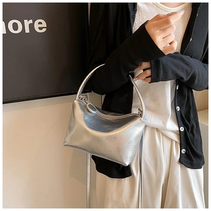 Detail of silver metallic mini bag with zip closure and elegant leather texture