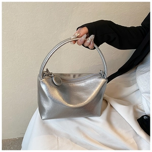 Close-up of a silver handbag with metallic pleated leather texture and sleek metal zipper