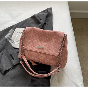 Detail of pink woven leather tote with silver chain strap and metal clasp accessory