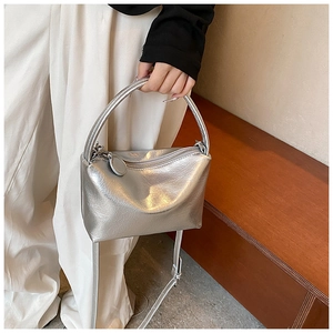 Detail of silver metallic wrinkled texture handbag with thin adjustable shoulder strap