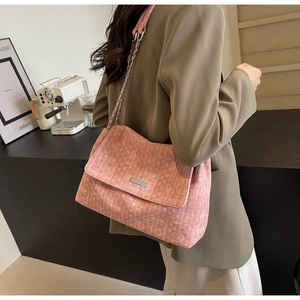 Detail showing pink woven texture and silver chain strap on a large tote bag
