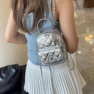 Silver quilted mini backpack with chain strap in diamond pattern for fashion use