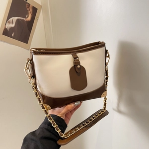 Retro contrast bucket bag in cream and brown leather with a gold chain strap