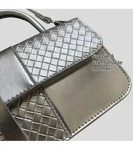 Detail of silver metallic woven handbag showing intricate intrecciato texture and shine