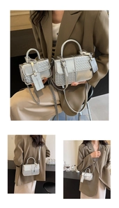Detail of silver metallic textured crossbody bag with woven panels and chain strap