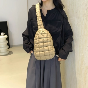Beige quilted nylon crossbody bag with large diamond stitching and wide strap