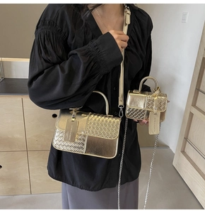 Detailed view of golden woven textured handbag set with dual pouches and chain strap