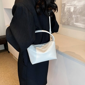 Chic white glossy leather tote bag for women featuring a minimalist trapezoid silhouette