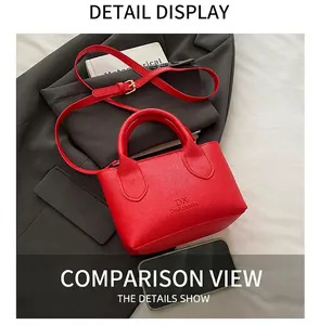 Detail of red lychee pattern leather crossbody bag with adjustable strap and brand logo