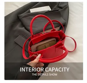 Interior detail of red lychee leather bucket bag showing large capacity for daily items