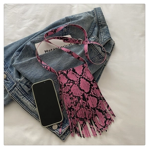 Pink snake skin crossbody bag featuring long fringes and adjustable silver metal buckle