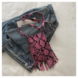 Close-up of pink snakeskin pattern crossbody bag with dense fringe and silver buckle
