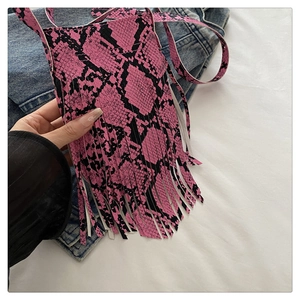 Detailed view of a pink snakeskin pattern phone bag with long decorative tassels