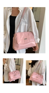 Detailed close-up of pink quilted leather shoulder bag with silver chain strap and metal buckle