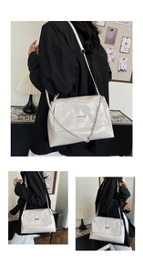 Detail of quilted rhombic stitching and metal clasp on beige large chain shoulder bag