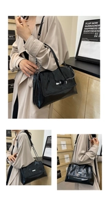 Detail of the black quilted leather texture and silver chain strap on the stylish shoulder bag
