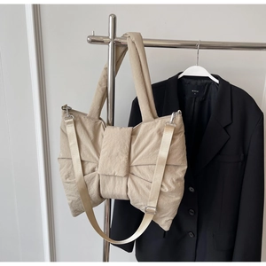 Detail of khaki ballet style bow tote bag with adjustable strap and silver buckles