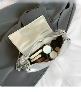 Interior view of silver chain bag showing spacious capacity for various cosmetics