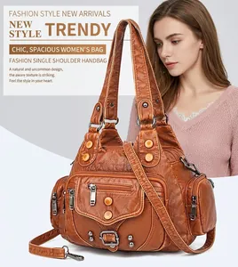 Detail view of large vintage brown washed leather tote bag with rivets and pockets