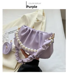 Detail der lila gerafften Cloud-Tasche mit Perlengriff und stilvollem Faltenriemen