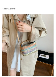 Detail of colorful ethnic woven square bag with khaki leather adjustable shoulder strap