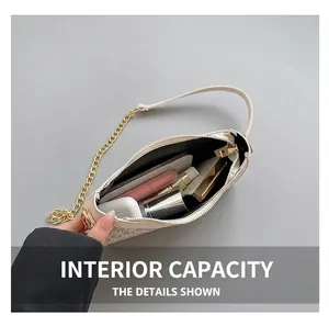 Interior view showing the large capacity of the beige patterned underarm bag for essentials