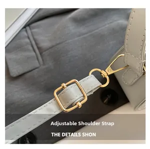 Detail of adjustable blue leather strap with premium gold metal buckle and stitching