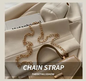 Detailed view of the gold chain strap and premium brown leather texture on a tote bag