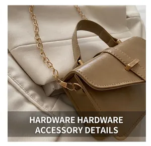 Close-up of golden metal hooks and chain strap on a khaki PU leather handbag