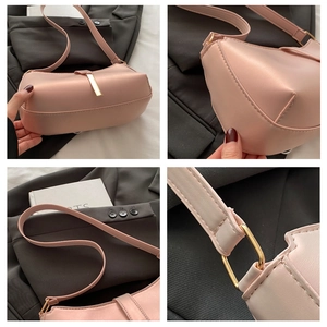 Detail view of pink PU leather underarm bag featuring golden metal buckles and smooth finish