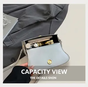 Interior view of grey crescent bag showing capacity for phone and cosmetics