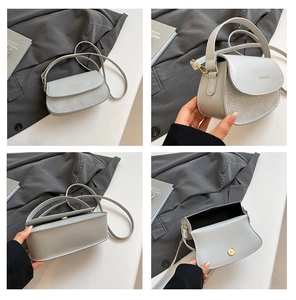 Detail view of grey semi-circle bag with sequins, magnetic closure and inner structure