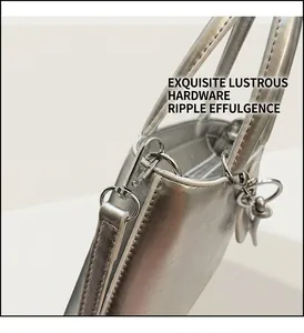 Detail shot of silver metallic bucket bag with shiny hardware and luxury leather texture