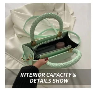 Interior view of crocodile-embossed green handbag with woven handle and zippered pocket