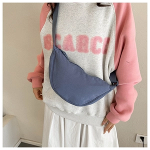 Detail of Morandi blue canvas half-moon crossbody bag with adjustable shoulder strap