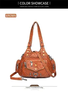 Detail view of brown washed leather tote with multiple functional zipper pockets and rivets